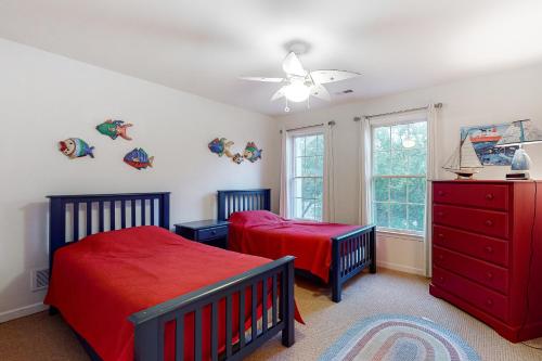a bedroom with two beds and a red dresser at Bethany Lakes - 31292 May in Bethany Beach