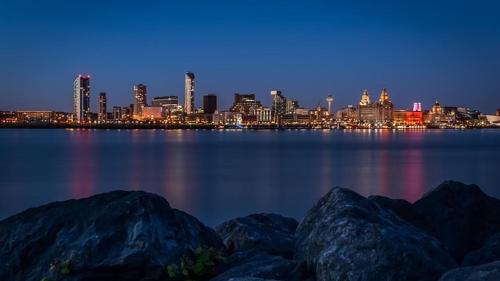 a view of a city from the water at night at Holiday Inn Liverpool City Centre by IHG in Liverpool