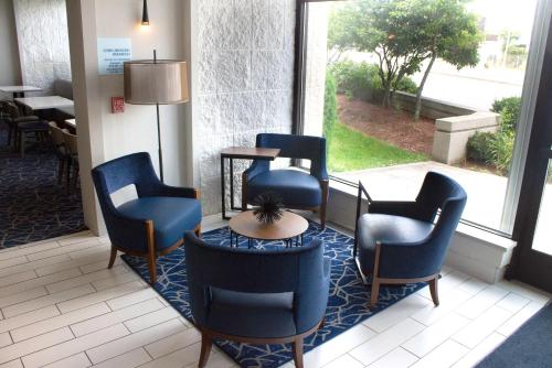 a waiting room with blue chairs and a table at Holiday Inn Express & Suites Boston - Cambridge by IHG in Cambridge