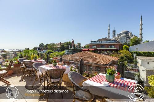 people sitting at tables with umbrellas at Best Point Hotel Old City - Best Group Hotels in Istanbul