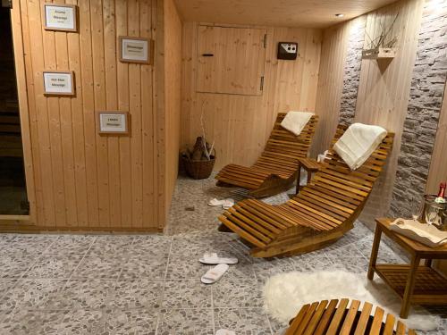 a room with three lounge chairs and a table at Berghotel Drei Brüder Höhe in Marienberg