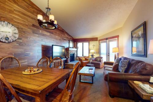 a living room with a table and a couch at Copper Valley 114 in Copper Mountain