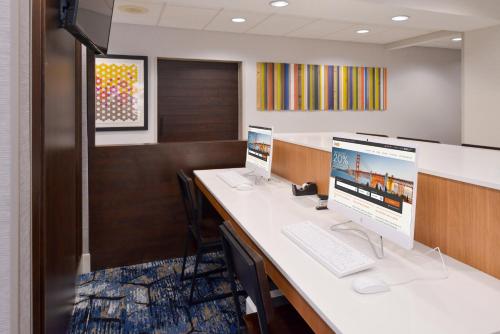 an office cubicle with two computers on a desk at Holiday Inn Express Wixom by IHG in Wixom