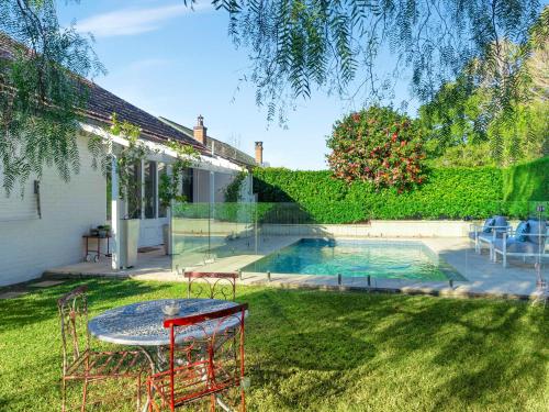 a backyard with a table and a swimming pool at Berry Bliss Berry in Berry