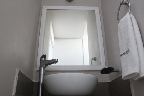 a bathroom with a white sink and a mirror at Hotel Florencia Poza Rica in Poza Rica de Hidalgo
