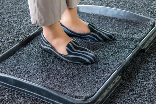 a person in black shoes standing on a table at Eurotel Vivaldi Araneta in Manila