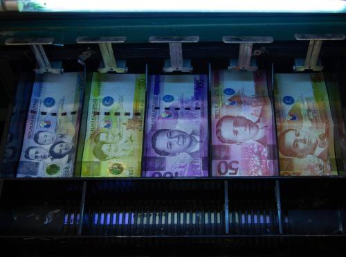 a bunch of money in bundles on a shelf at Eurotel Vivaldi Araneta in Manila