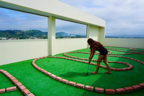 a woman playing golf on a virtual golf course at DEPARTAMENTO TOTALMENTE NUEVO, AMOBLADO Y DE LUJO EN TONSUPA in Tonsupa