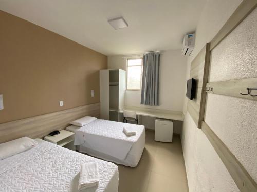 a hotel room with two beds and a window at Hotel Ryad Express in São Luís