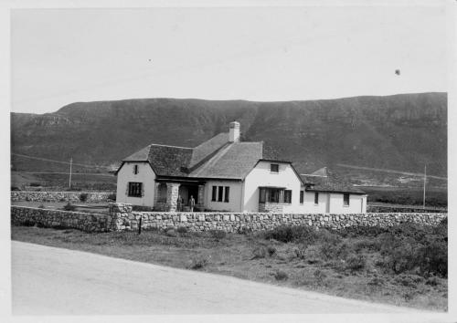 a black and white photo of a house on the side of a road at Mulligans Guest Lodge in Hermanus