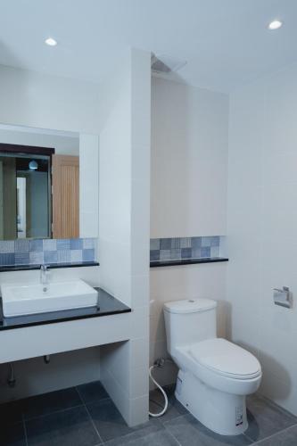 a bathroom with a toilet and a sink at The Cotton Tree Hometel in Khon Kaen
