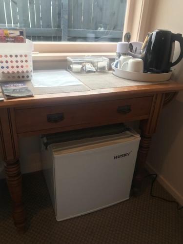 a kitchen counter with a table with a tea pot on it at TAURANGA, Bay of Plenty in Tauranga