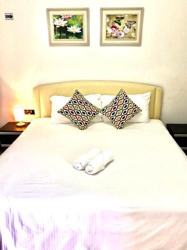 a bed with two bowties on top of it at Kerteh Apartment in Kertih