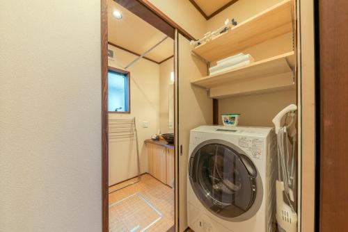 a laundry room with a washer and dryer at YADOYA Hakuteian in Tokyo