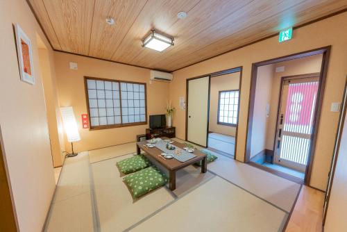 a room with a table and chairs in a room at YADOYA Hakuteian in Tokyo