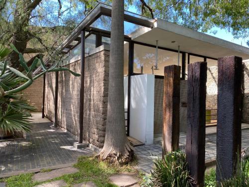 a brick house with a tree in front of it at Posada Colibri - Hotel & Spa in San Juan Teotihuacán