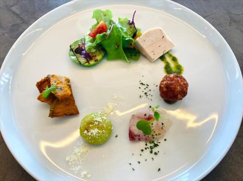 a white plate topped with different types of food at HOTEL ANTEROOM NAHA in Naha