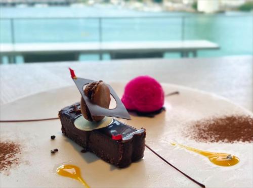 a piece of chocolate dessert on a plate with a pastery at HOTEL ANTEROOM NAHA in Naha