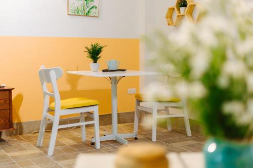 a table and chairs in a room with a table at Sunstay Paradise in Hanoi