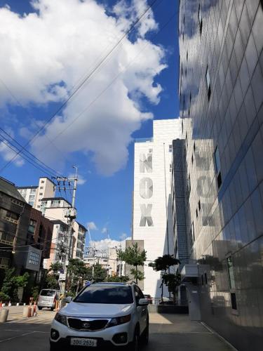 a white car parked in front of a building at Bestel Residence in Seoul