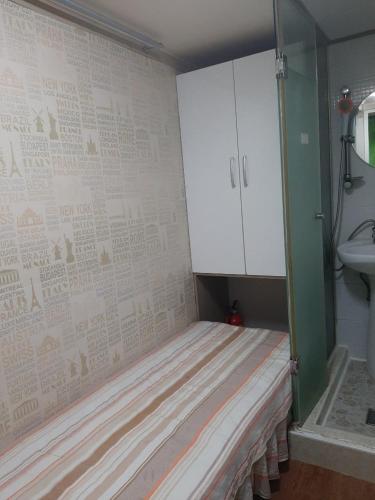 a small room with a bed and a sink at Bestel Residence in Seoul