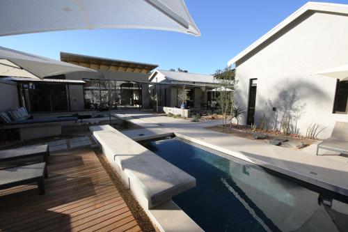 a swimming pool in the backyard of a house at The Elegant Guesthouse in Windhoek