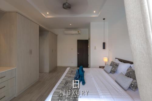a bedroom with a large bed with a blue towel on it at Modern 3 Bedroom Private Pool Villa - MP67 in Hua Hin
