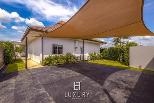 a house with a driveway in front of it at Modern 3 Bedroom Private Pool Villa - MP67 in Hua Hin