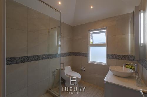 a bathroom with a glass shower and a sink at Modern 3 Bedroom Private Pool Villa - MP67 in Hua Hin