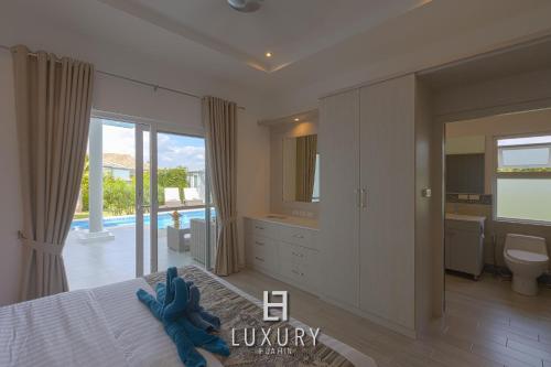 a bedroom with a blue elephant on a bed at Modern 3 Bedroom Private Pool Villa - MP67 in Hua Hin