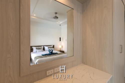 a bedroom with a large mirror on the wall at Modern 3 Bedroom Private Pool Villa - MP67 in Hua Hin