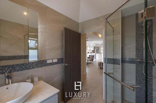 a bathroom with a sink and a glass shower at Modern 3 Bedroom Private Pool Villa - MP67 in Hua Hin