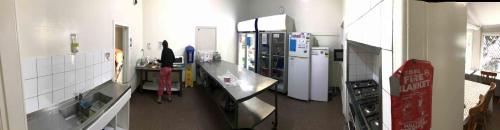 a kitchen with white counter tops and appliances at Wander Inn Bunbury in Bunbury