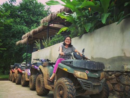a woman sitting on the back of a four wheeler at Cheeva at pai ชีวา แอท ปาย in Pai