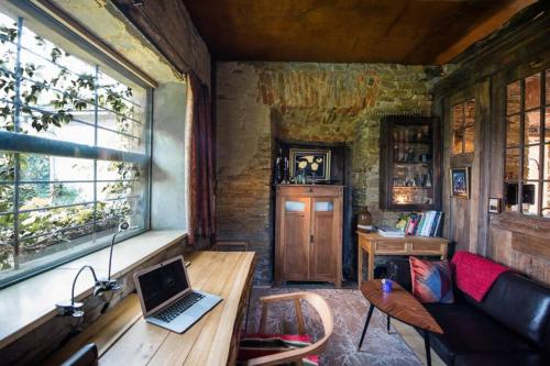 a living room with a couch and a laptop on a table at Mała Kuźnia in Lanckorona