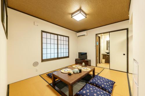 a living room with a table and two chairs at YADOYA Sennokawa in Tokyo