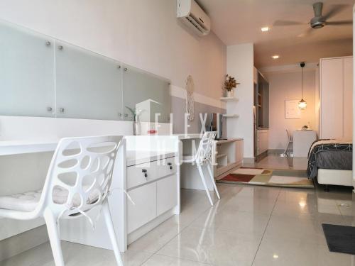 a kitchen with white cabinets and white chairs in a room at 9am-5pm, SAME DAY CHECK IN AND CHECK OUT, Work From Home, Shaftsbury-Cyberjaya, Comfy Home by Flexihome-MY in Cyberjaya