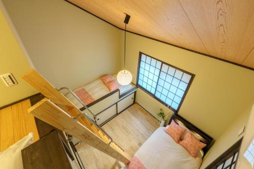 an overhead view of a room with two beds and a window at YADOYA Sennokawa in Tokyo