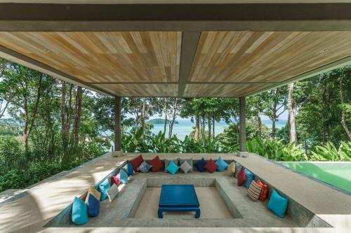 an outdoor living room with a couch and chairs at Island Escape Burasari in Phuket Town