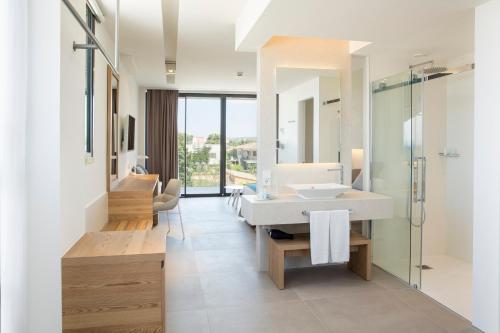 a bathroom with a sink and a glass shower at Bordoy Cosmopolitan in Playa de Palma