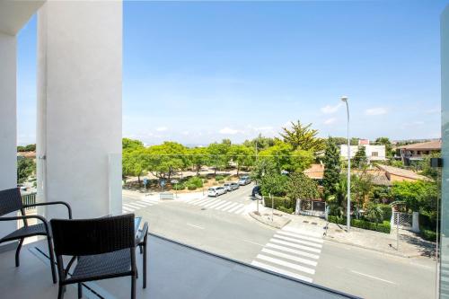 a balcony with chairs and a view of a street at Bordoy Cosmopolitan in Playa de Palma
