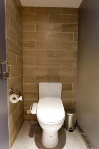 a bathroom with a toilet and two rolls of toilet paper at MU House in Taipei