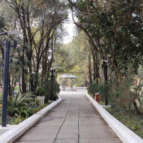 a walkway in a park with trees and lights at Park Village Resort by KGH Group in Kathmandu
