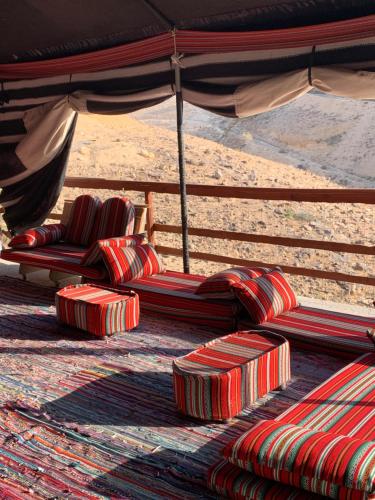 a group of chairs under an umbrella on the beach at אוהל לוט in Arad
