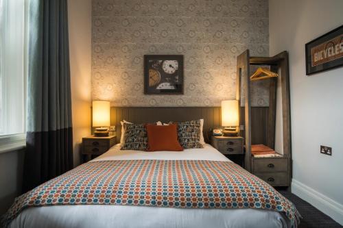 a bedroom with a large bed and two night stands at Toll House Inn in Lancaster