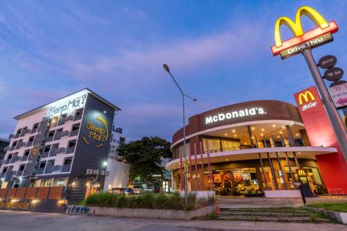 a mcdonalds building with a sign in front of it at Sleep Mai Chiang Mai Airport Lifestyle Hotel - SHA Plus in Chiang Mai