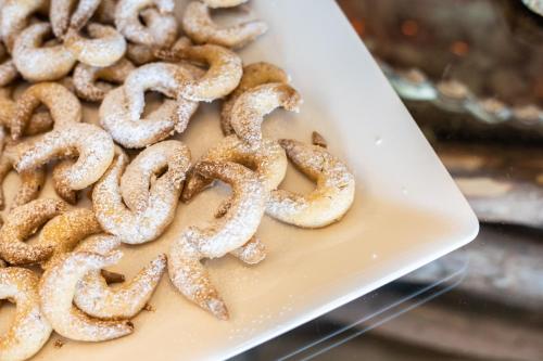 a pile of pretzels on a white plate at MyTime Hotels la Grotta in Vigo di Fassa