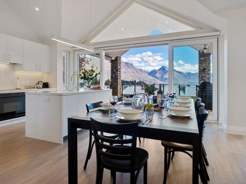 a kitchen and dining room with a table and chairs at Stonehill Villa - 5 Bed in Queenstown