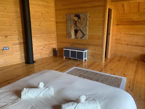 a bedroom with a bed and a picture of a woman at Casa Rural Rio Chicamo in La Umbría