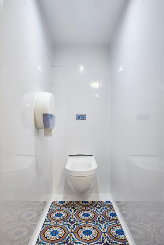 a bathroom with a toilet and a tile floor at hotelF1 Lyon Sud Oullins Rénové in Oullins